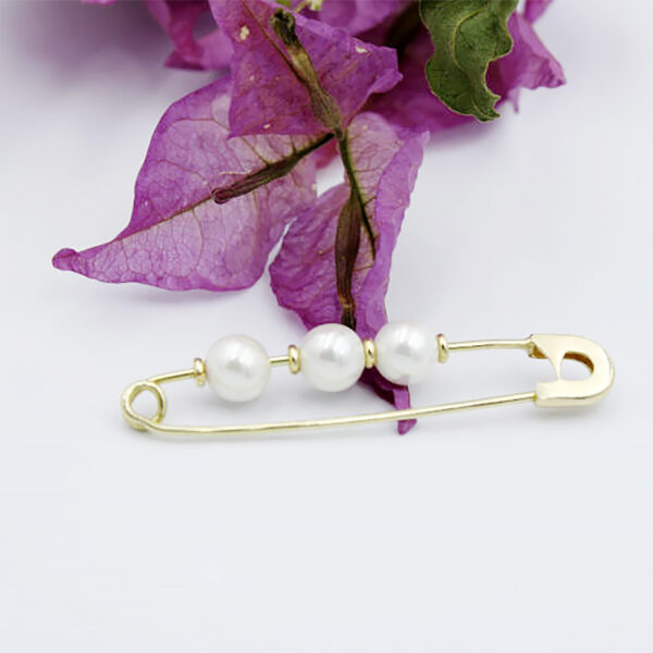 Broche de oro para bebé con flores